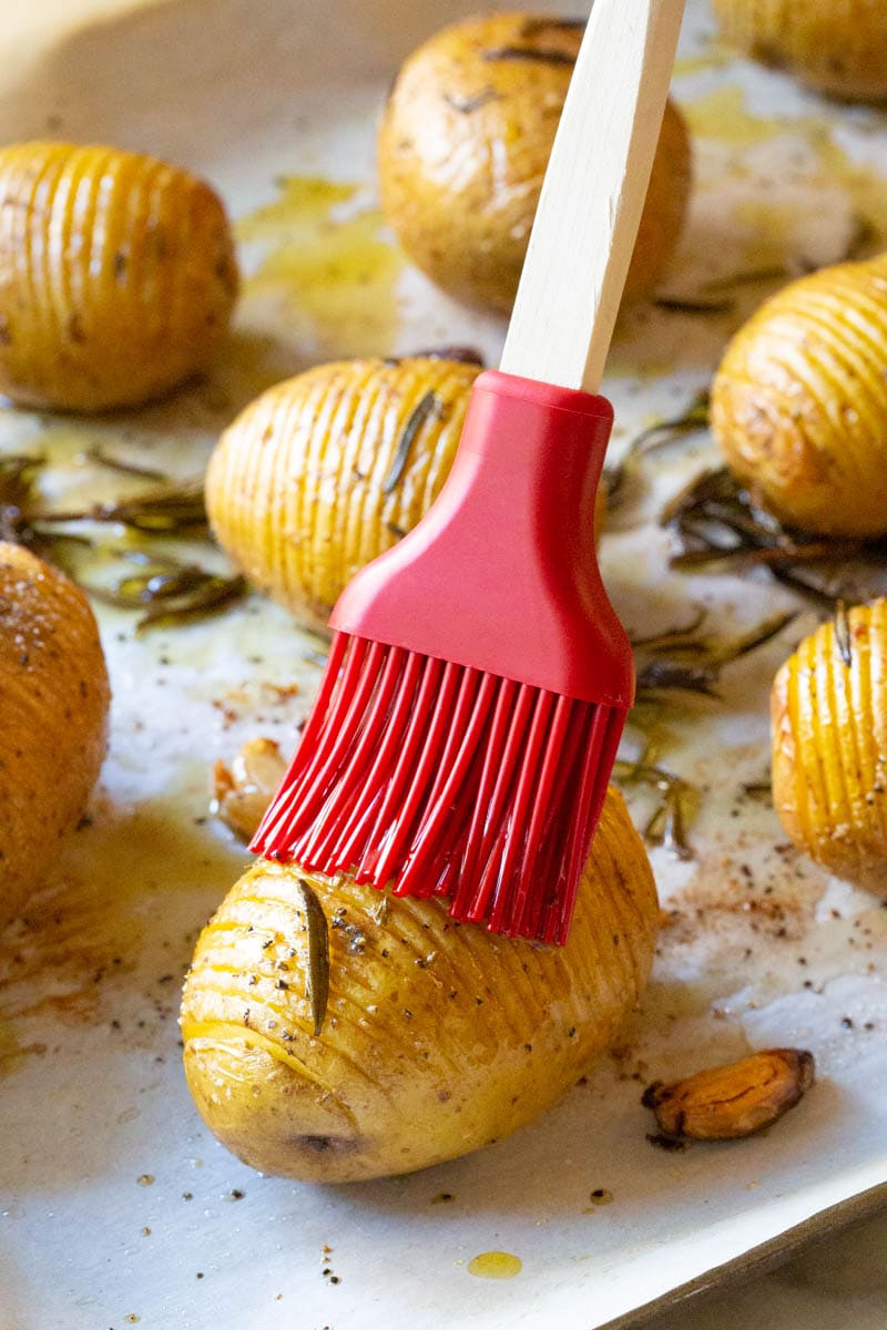 Brush seasoning potatoes.