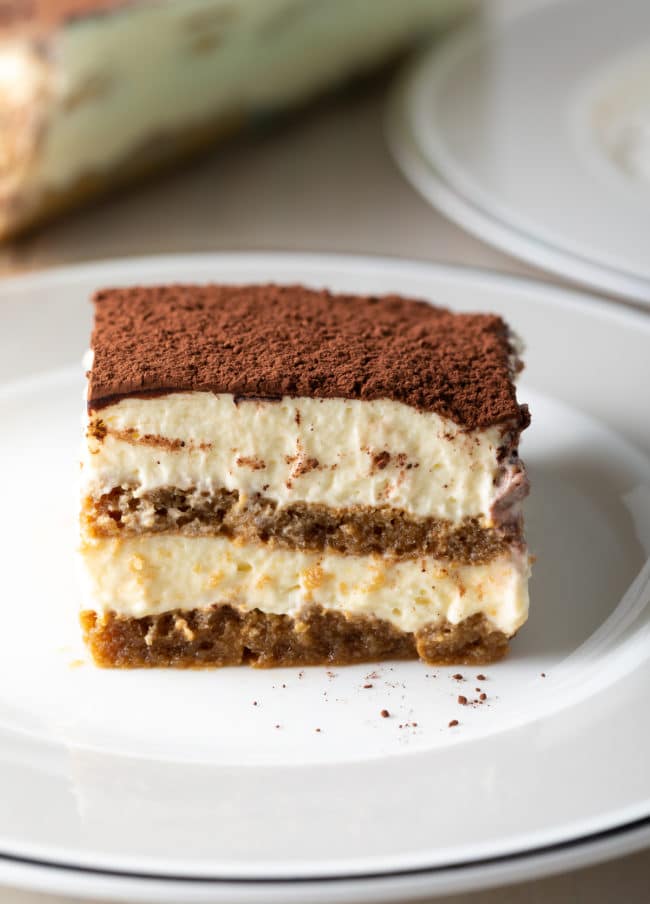 Slice of Tiramisu on a white plate.