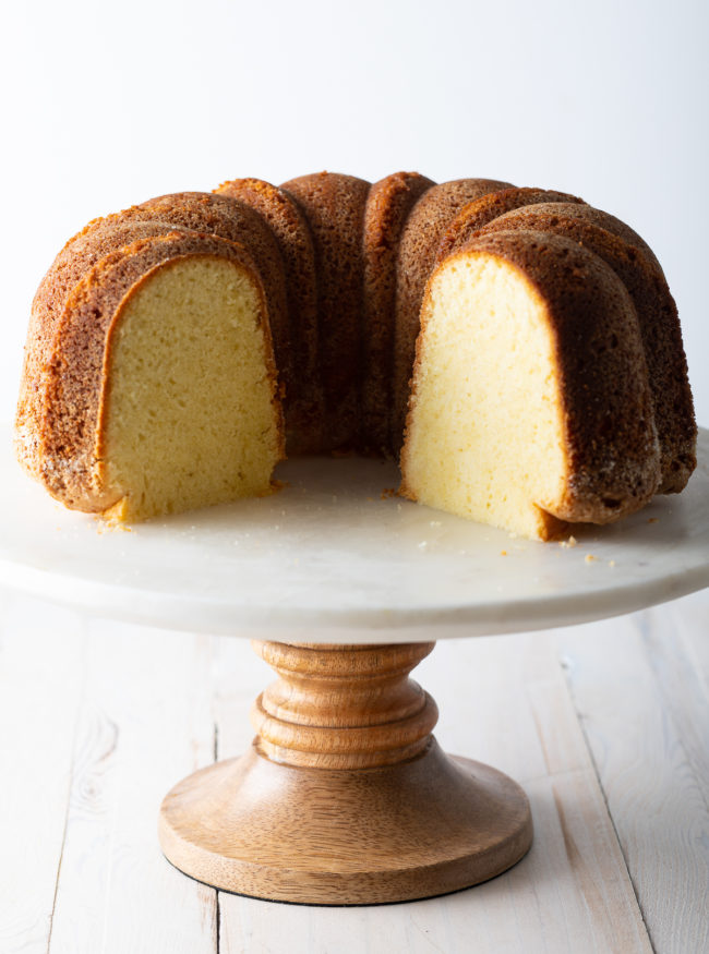 Side view of a cake stand with a sliced bundt cake so you can see the inside texture 
