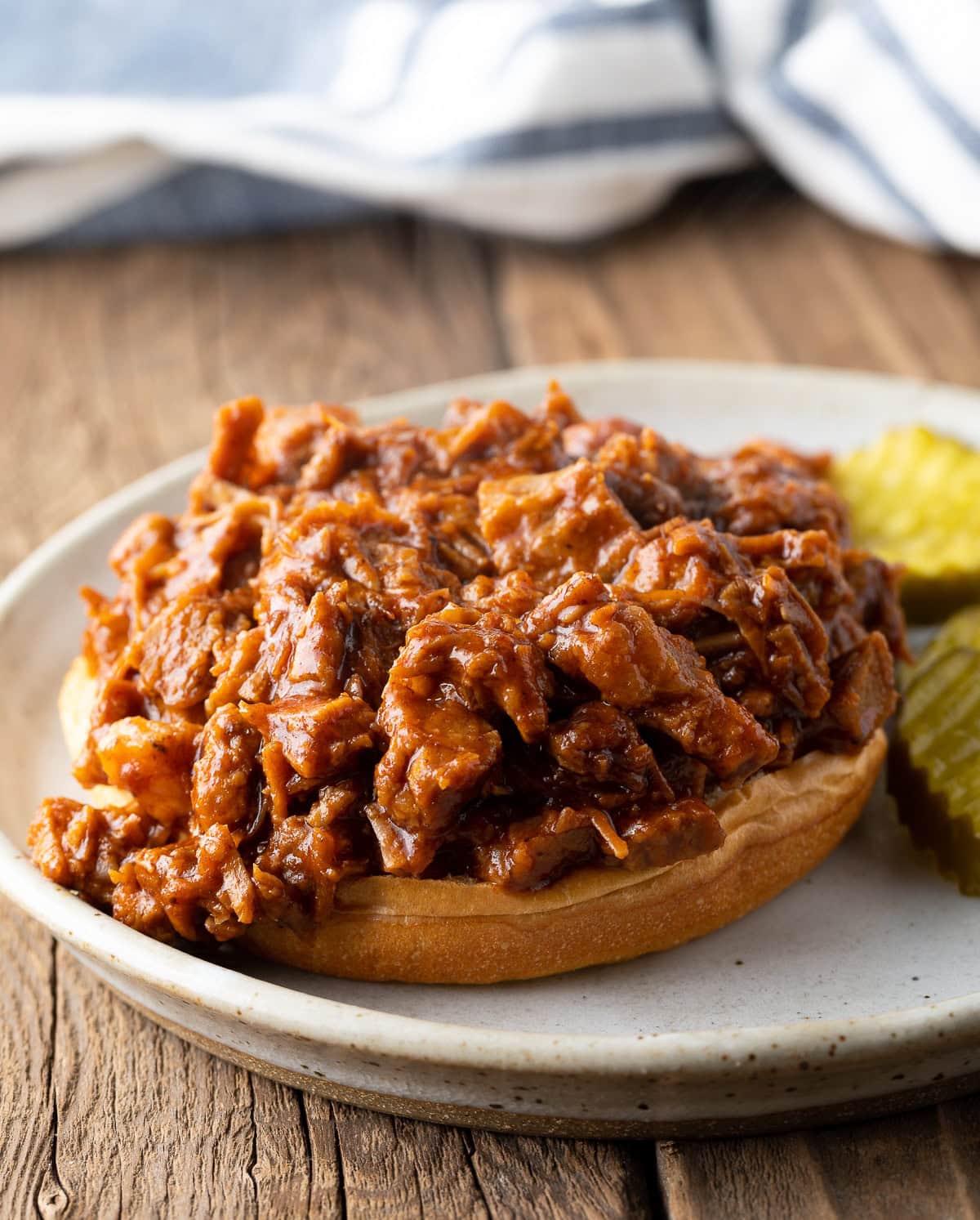 Open face chopped beef brisket on a bun.