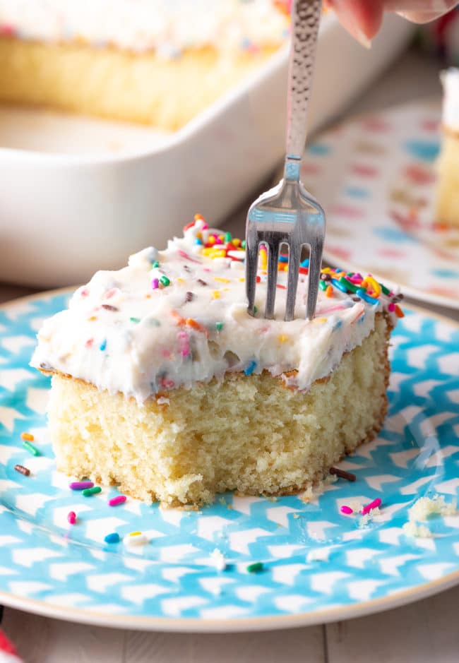 Fork removing a bite of funfetti cake. 