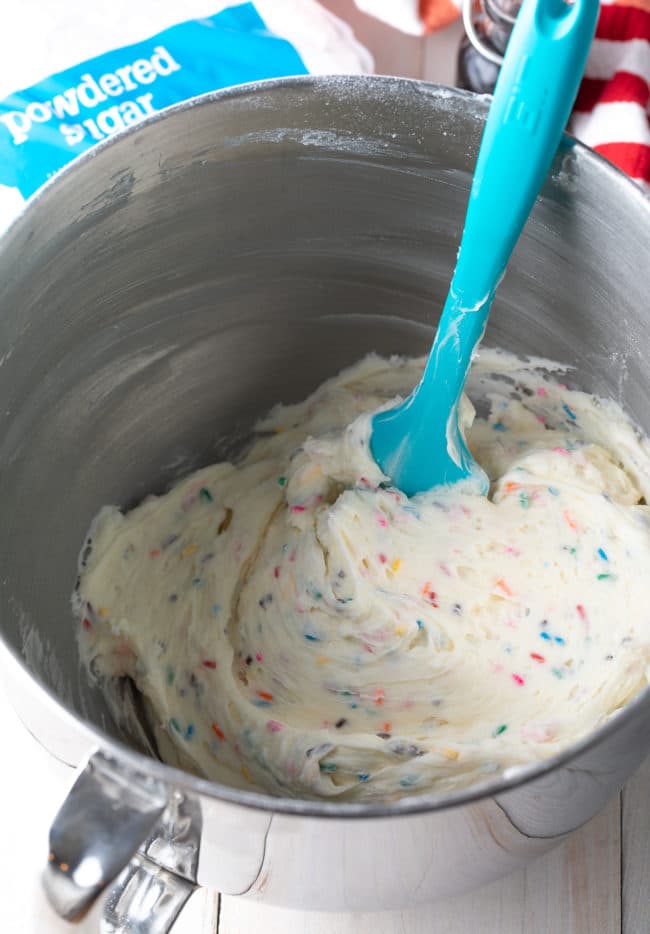 Spatula mixing together cream mixture. 