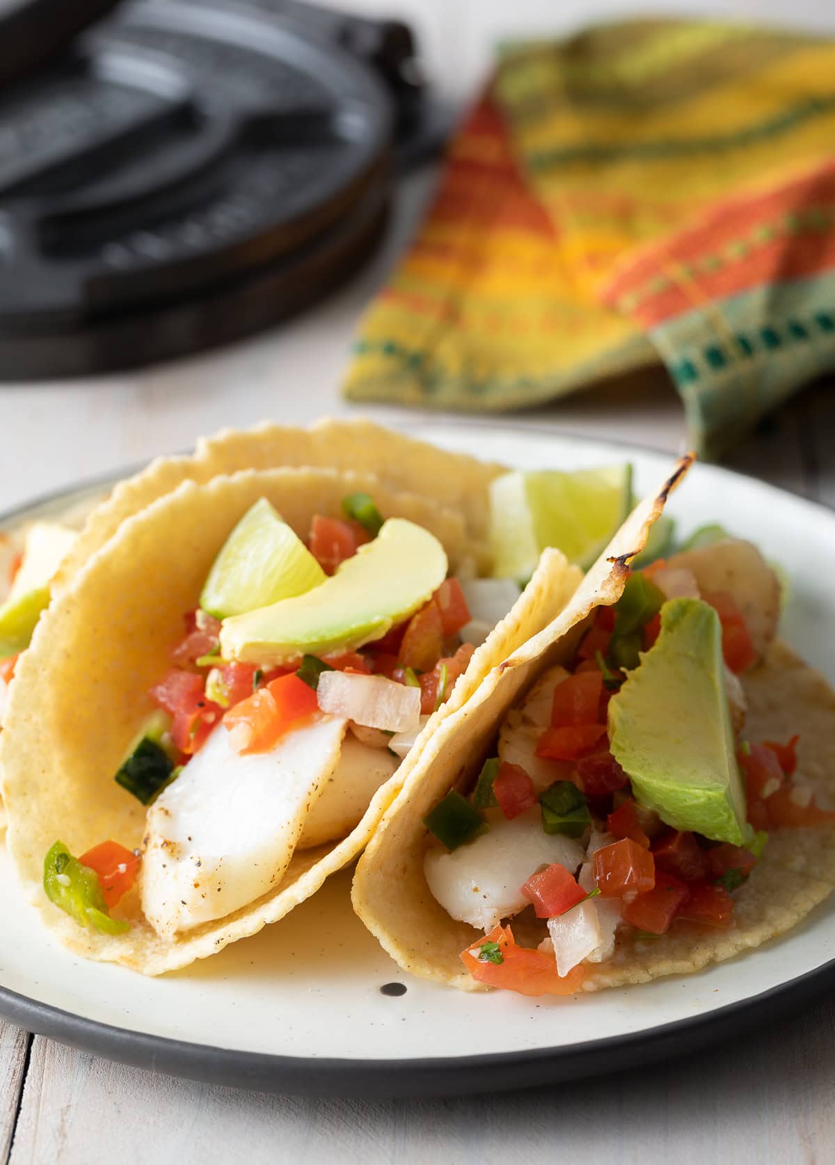 Tortillas filled with chicken, salsa and avocado on a plate. 
