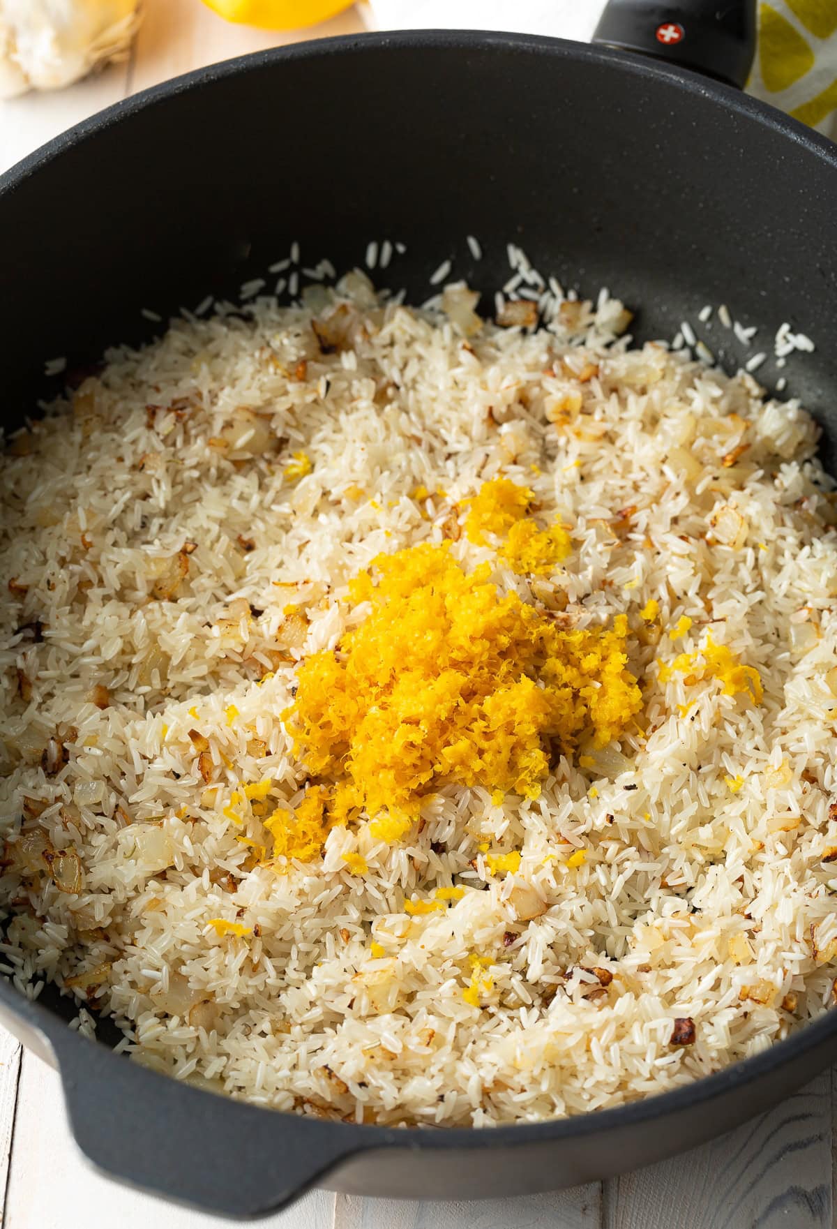 Rice and spices added to skillet.