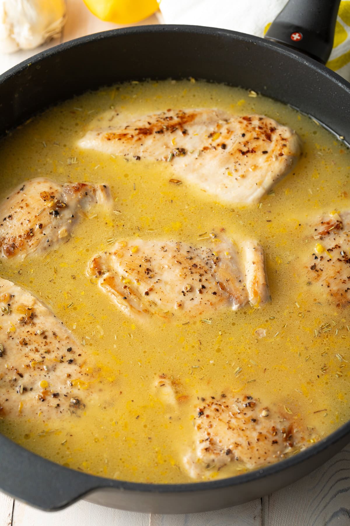 Skillet filled with rice, chicken and broth.