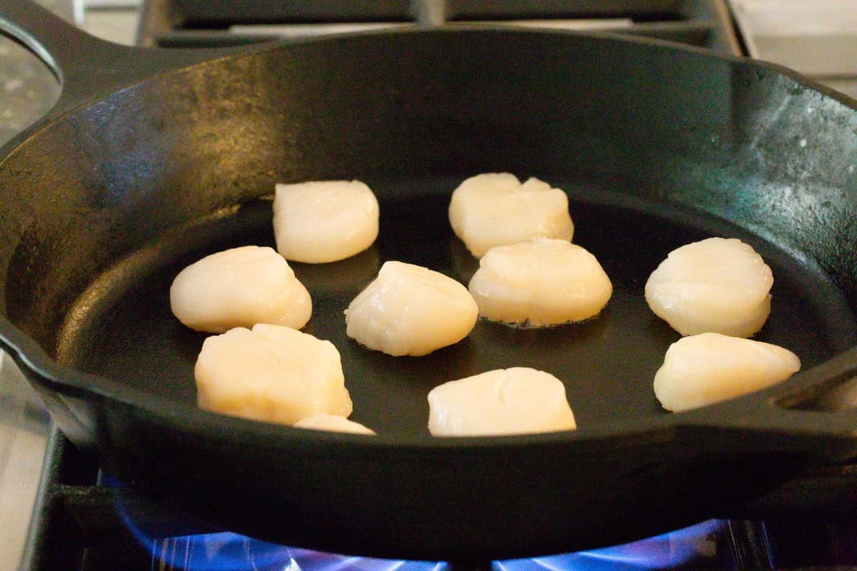 raw scallops in pan over high heat