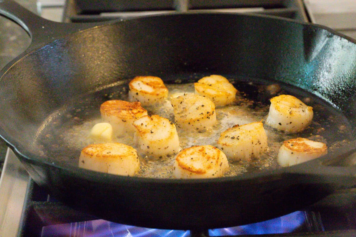 cooking seafood in a hot skillet