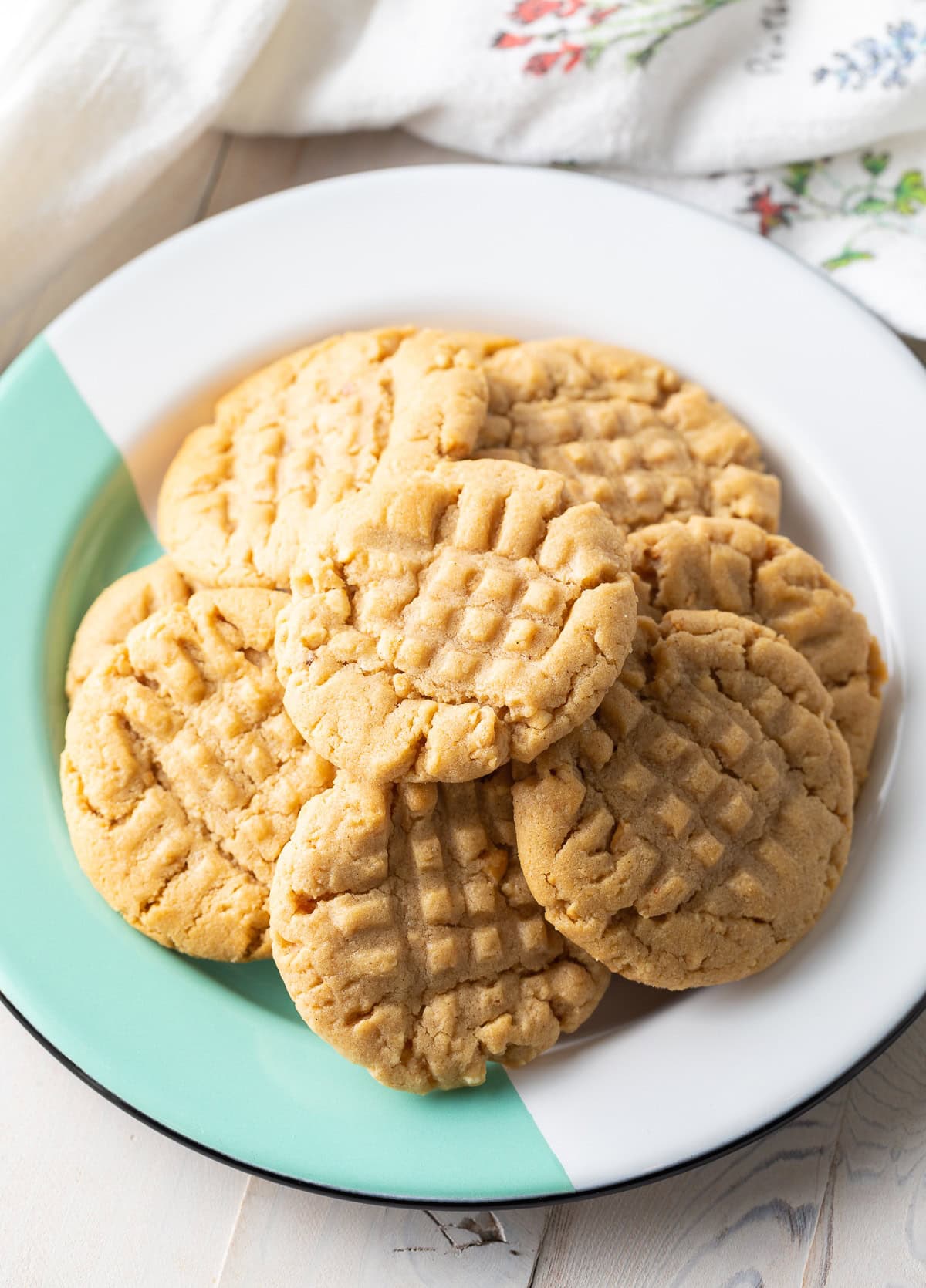 Chewy Best Peanut Butter Cookies Recipe with Peanuts piled on green and white plate