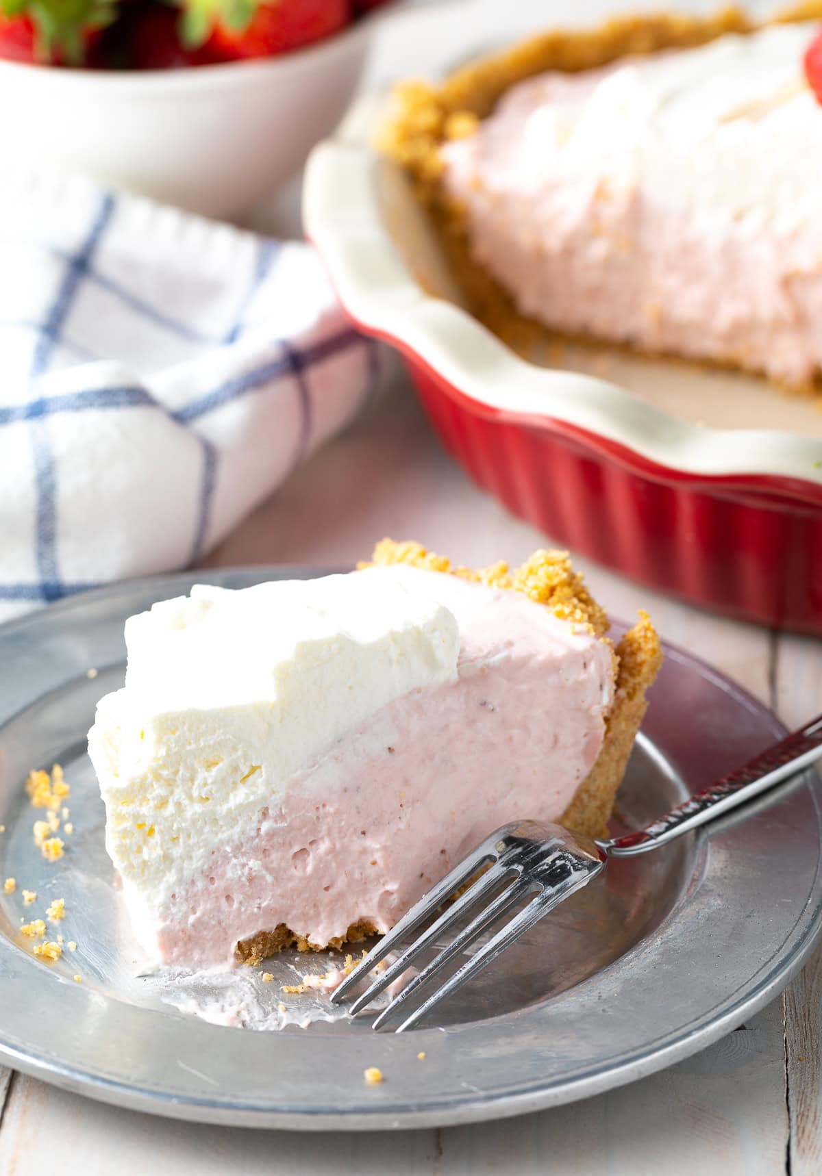 Fork taking a bite out of a slice of pie. 