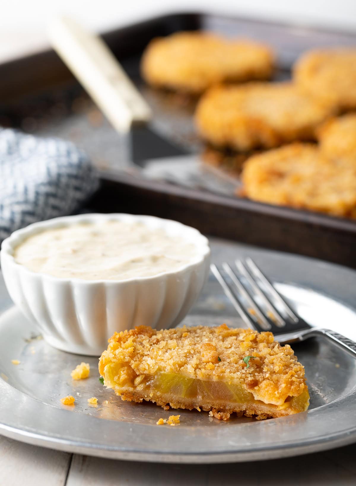 Plate with half eaten fried green tomato.
