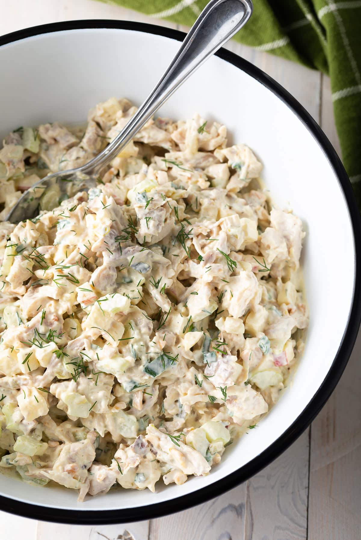 Top down view of southern chicken salad in a white and black bowl.