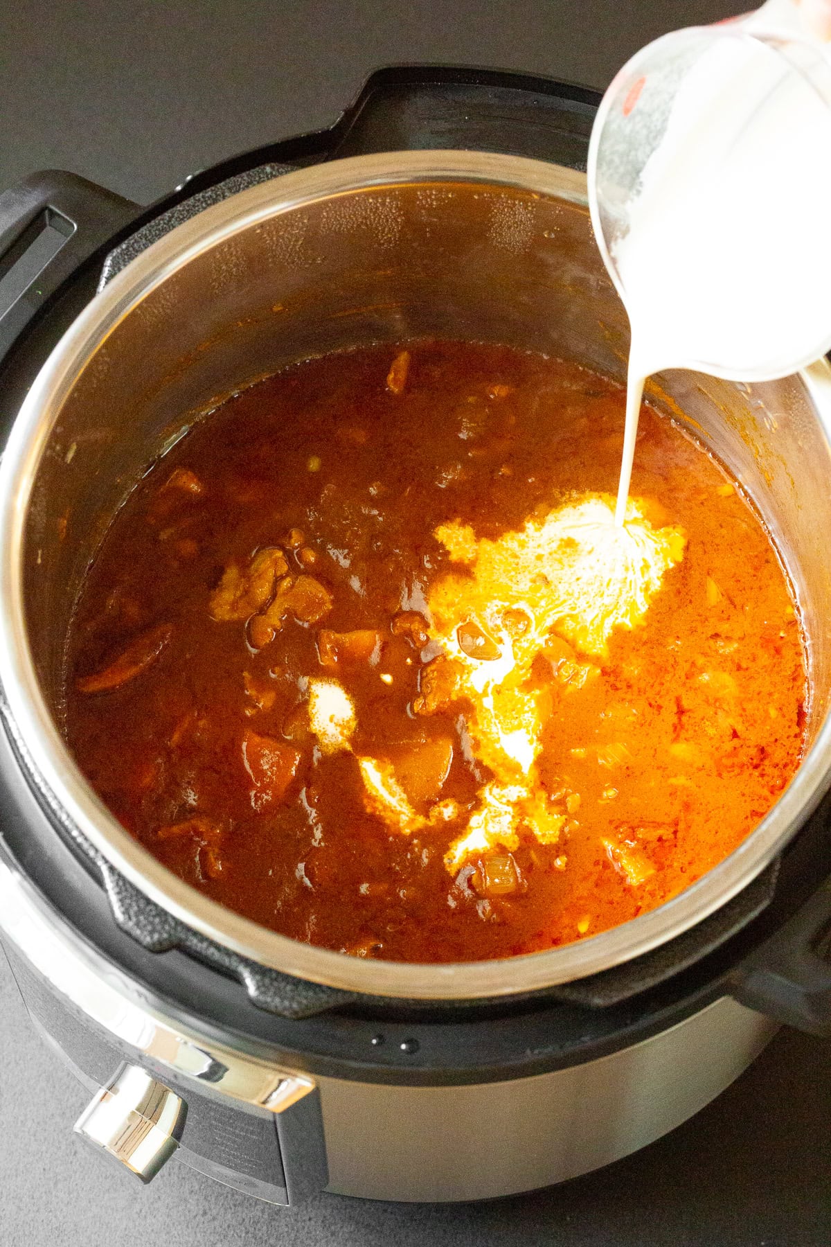 Cream being poured into Instant Pot. 