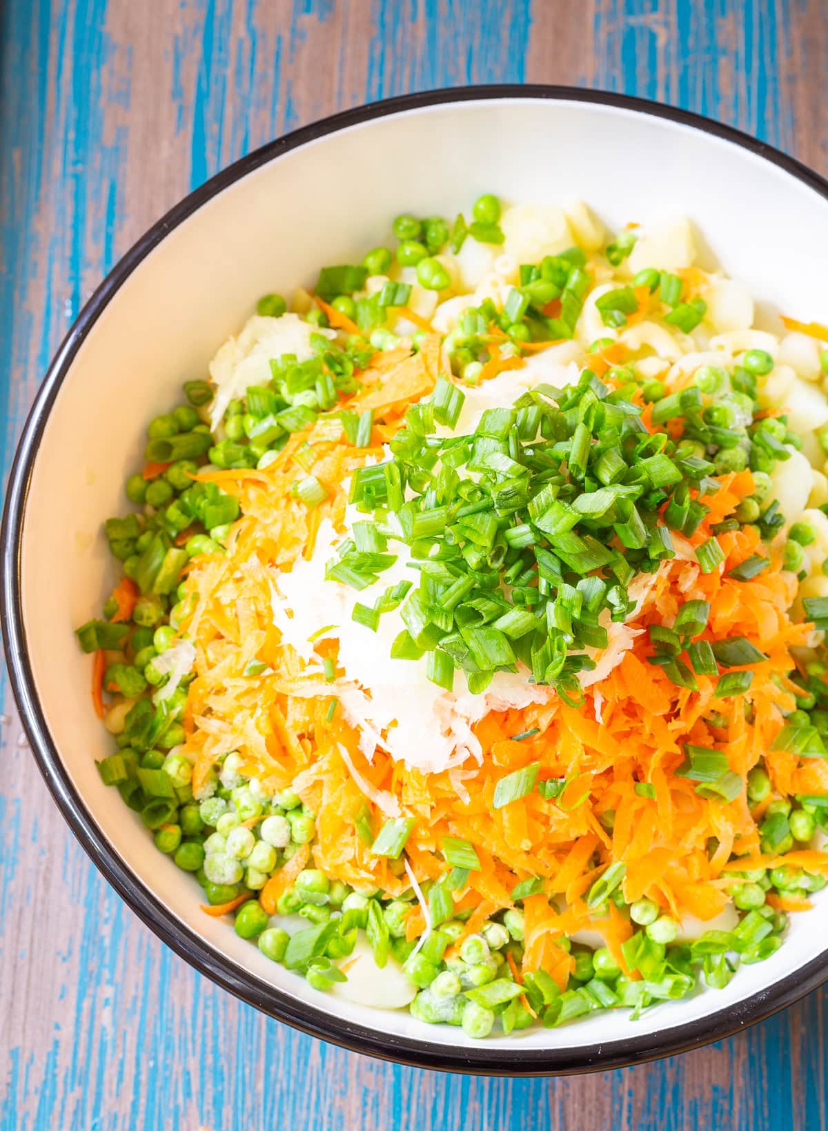 Ingredients for Hawaiian style macaroni salad in a large mixing bowl before being mixed. 