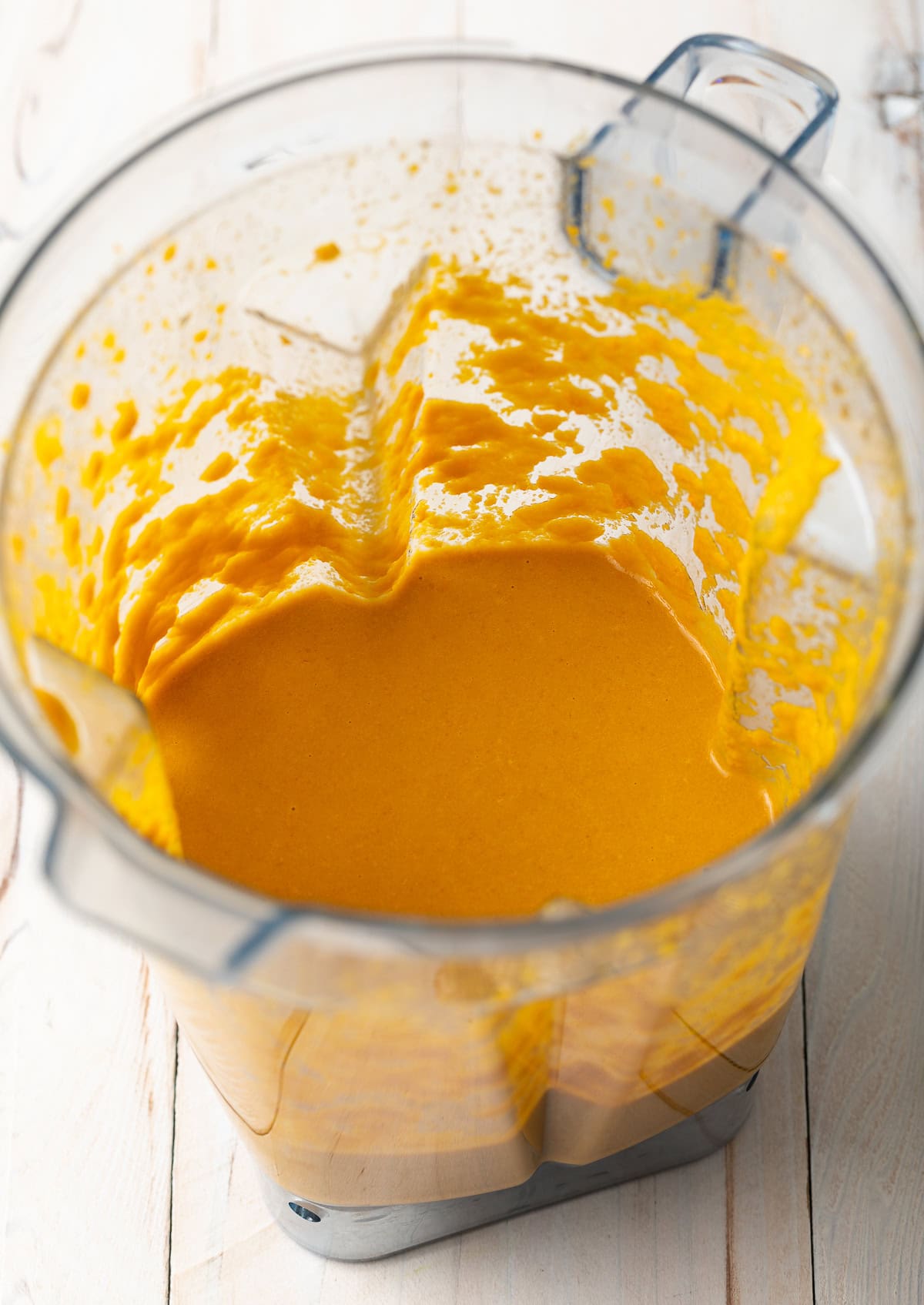 Mixed and pureed ingredients for salad dressing in a blender. 