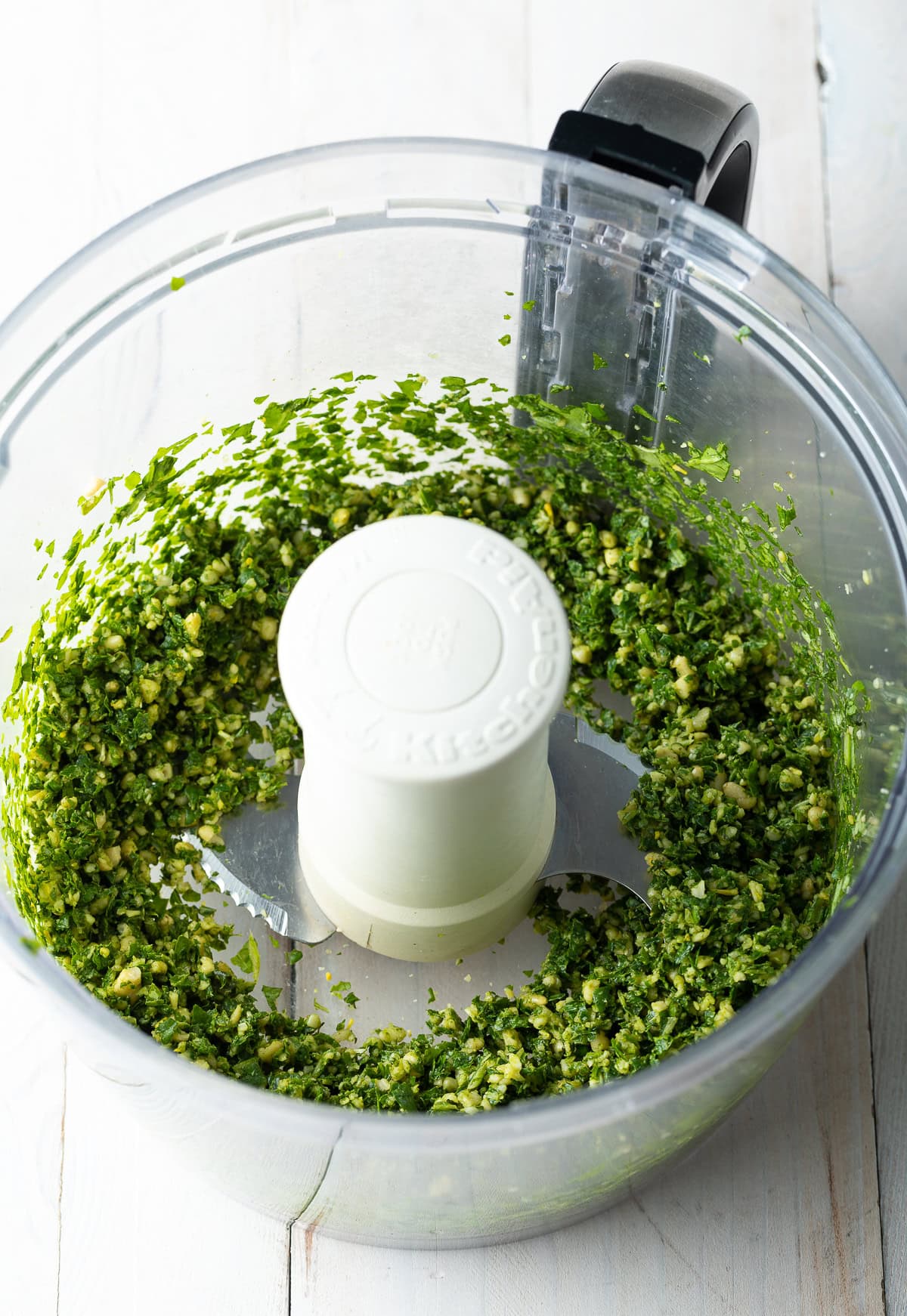 Closeup of finely ground ingredients in a food processor. 