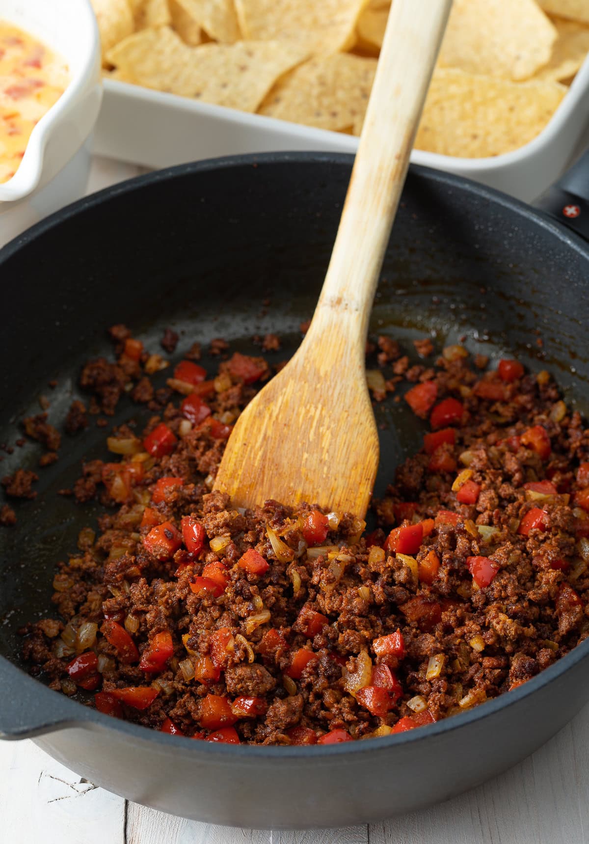 Chorizo and veggies cooking in a skillet. 