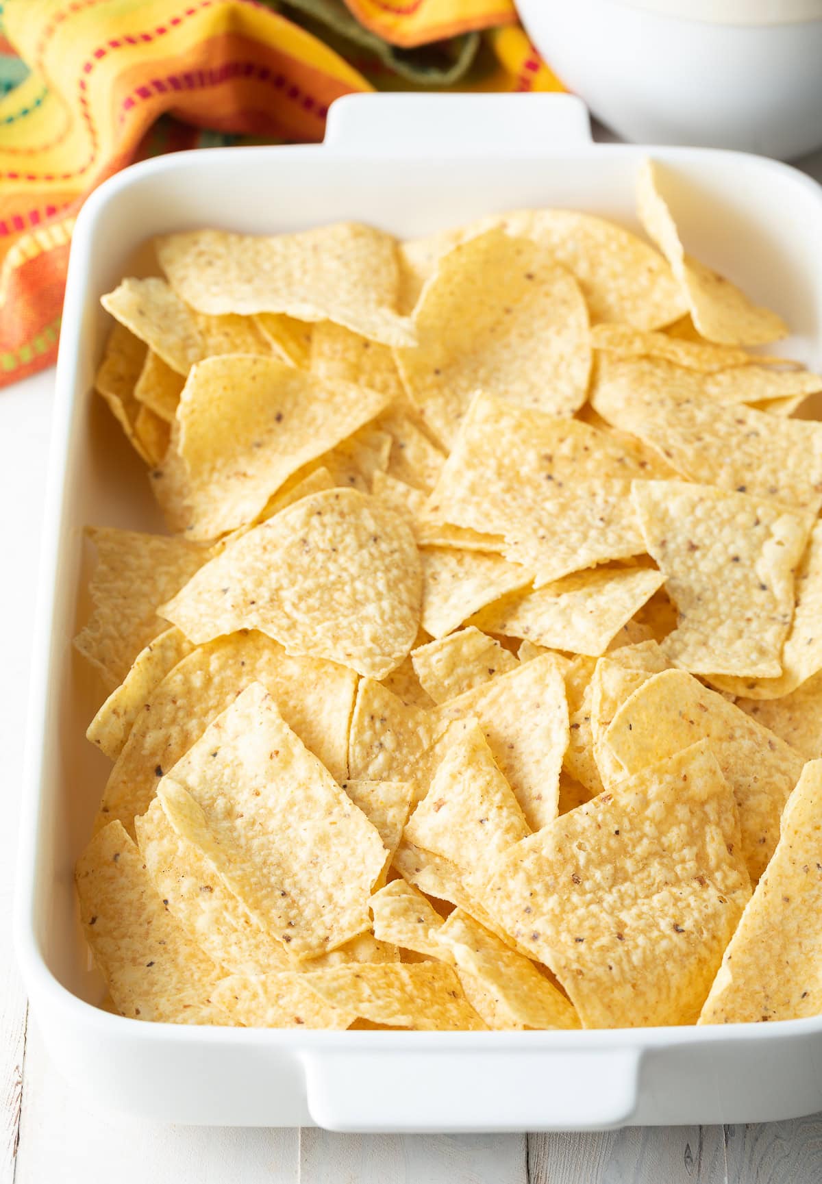 Baking dish topped with tortilla chips. 