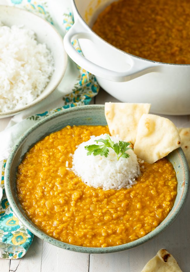 homemade Moong Dal served with white rice and pita bread, topped with parsley