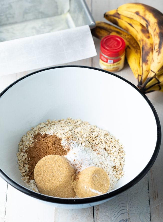 Dry ingredients for banana bread added into bowl.