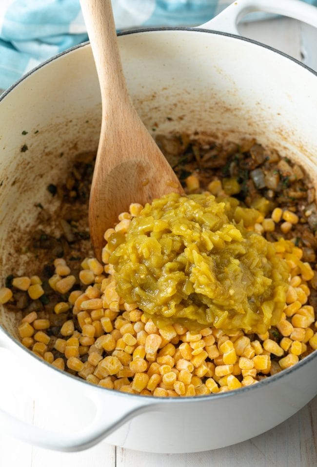 corn and green chiles added to pot
