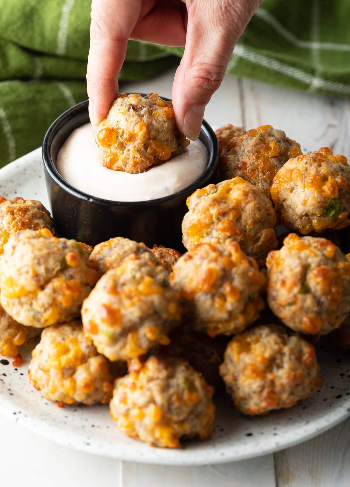 retro sausage balls recipe dunked in creamy sauce