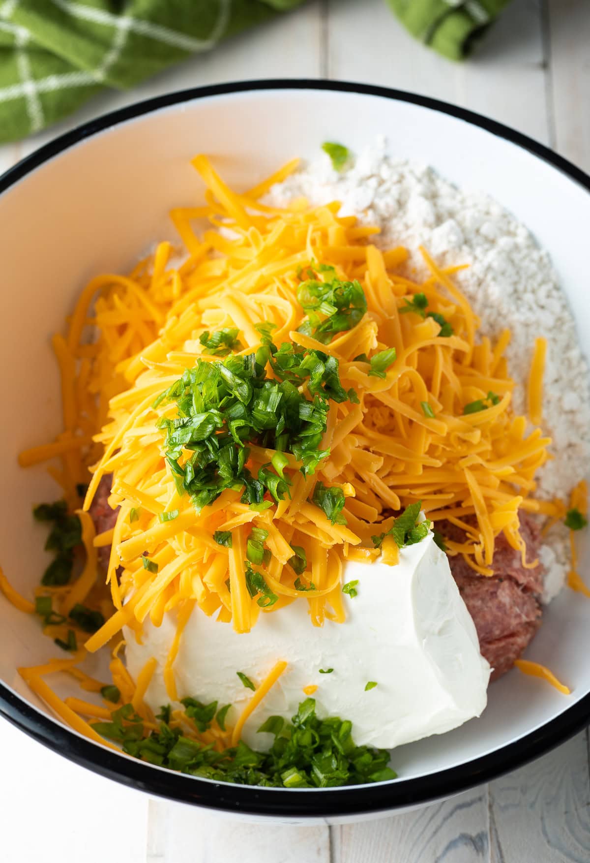 pork, cheddar, cream cheese, chives, and Bisquick mixed in a bowl