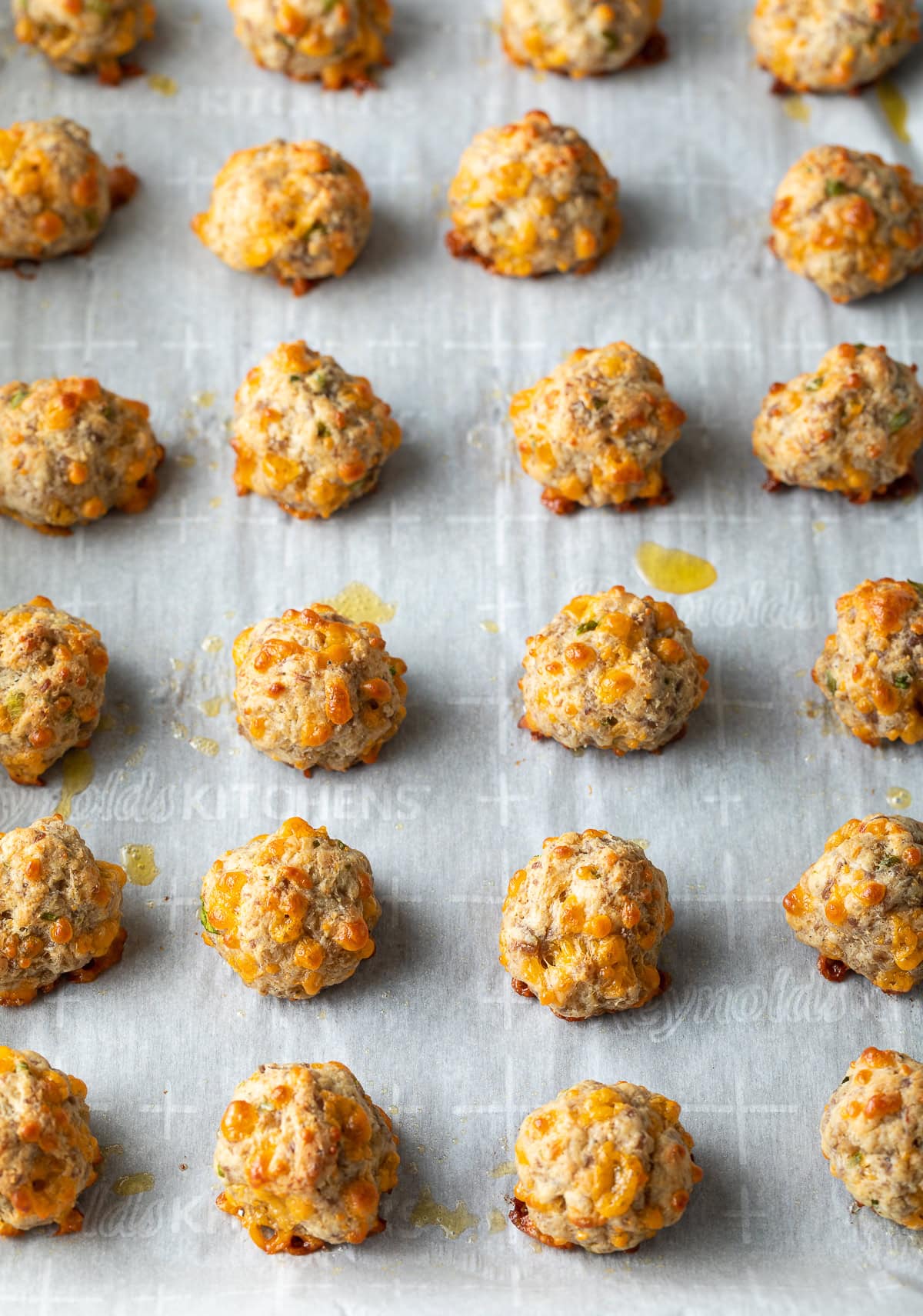 the best easy sausage cheese balls recipe baked on a cookie sheet