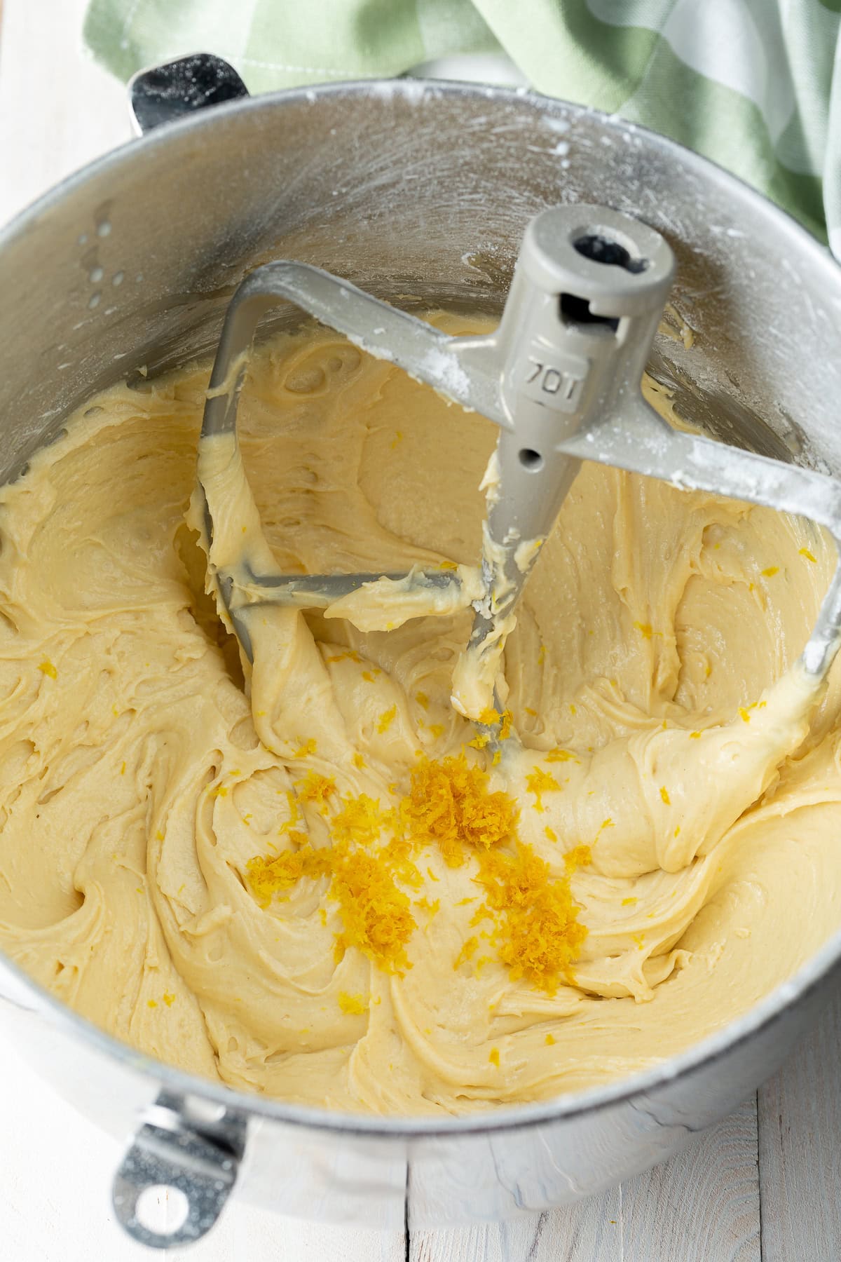 A blueberry muffin recipe mixture is being mixed in a stand mixer.