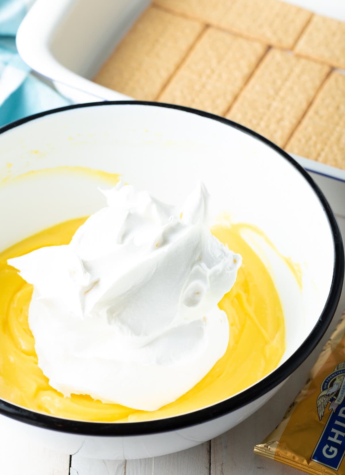 Bowl filled with pudding cream and a dollop of Cool Whip.