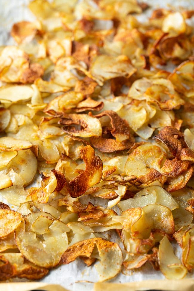 Oven roasted potato ribbons on a baking sheet.