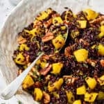 Black Rice Recipe in white bowl with spoon and butternut squash
