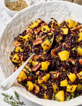 Black Rice Recipe in white bowl with spoon and butternut squash