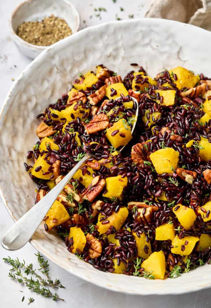 Black Rice Recipe in white bowl with spoon and butternut squash
