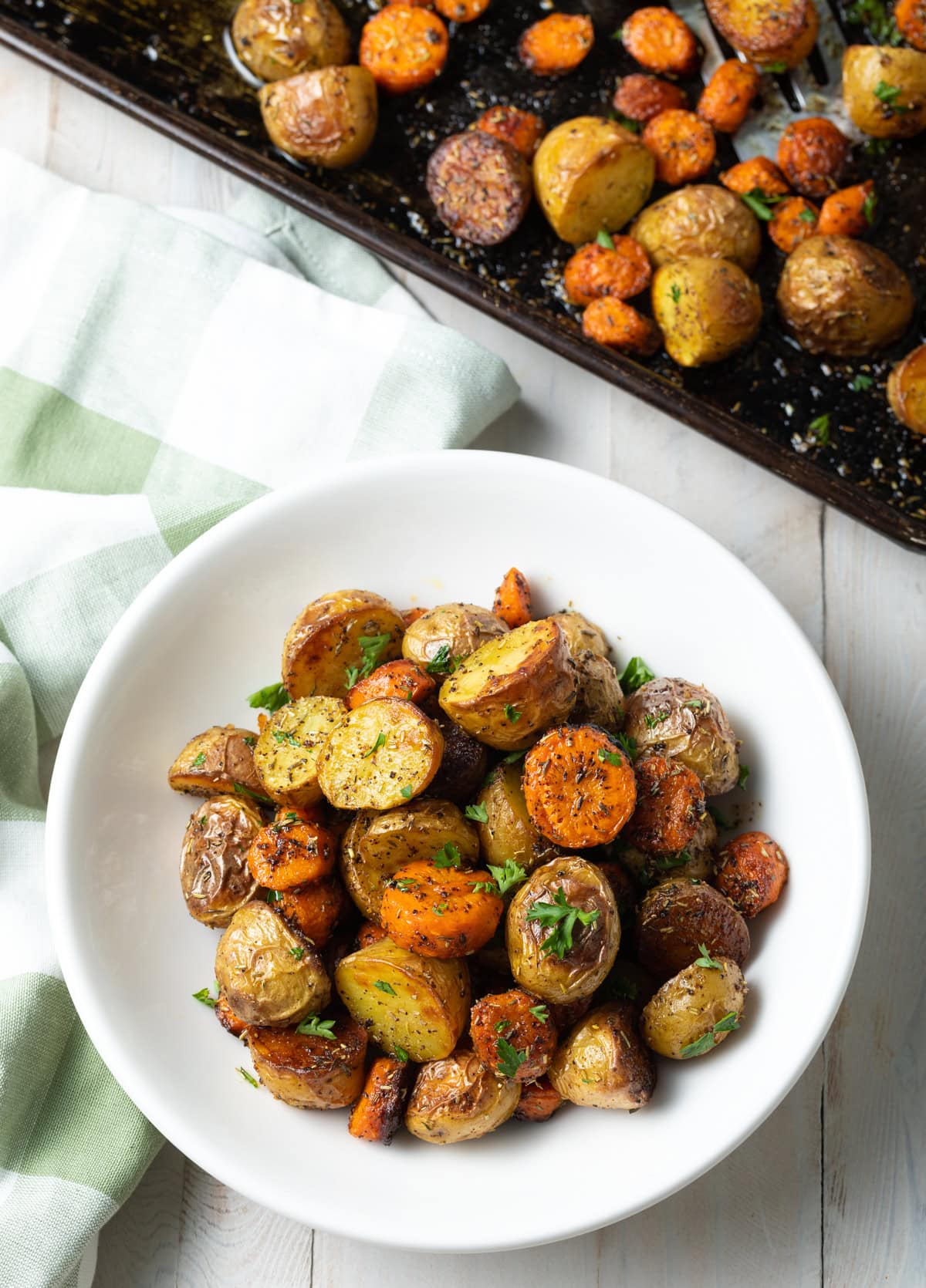 Top down view of roasted veggies and herbs