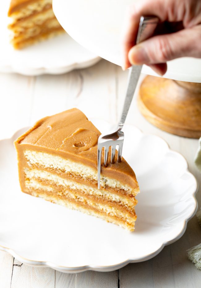 four layers of white cake with a thick salted caramel frosting