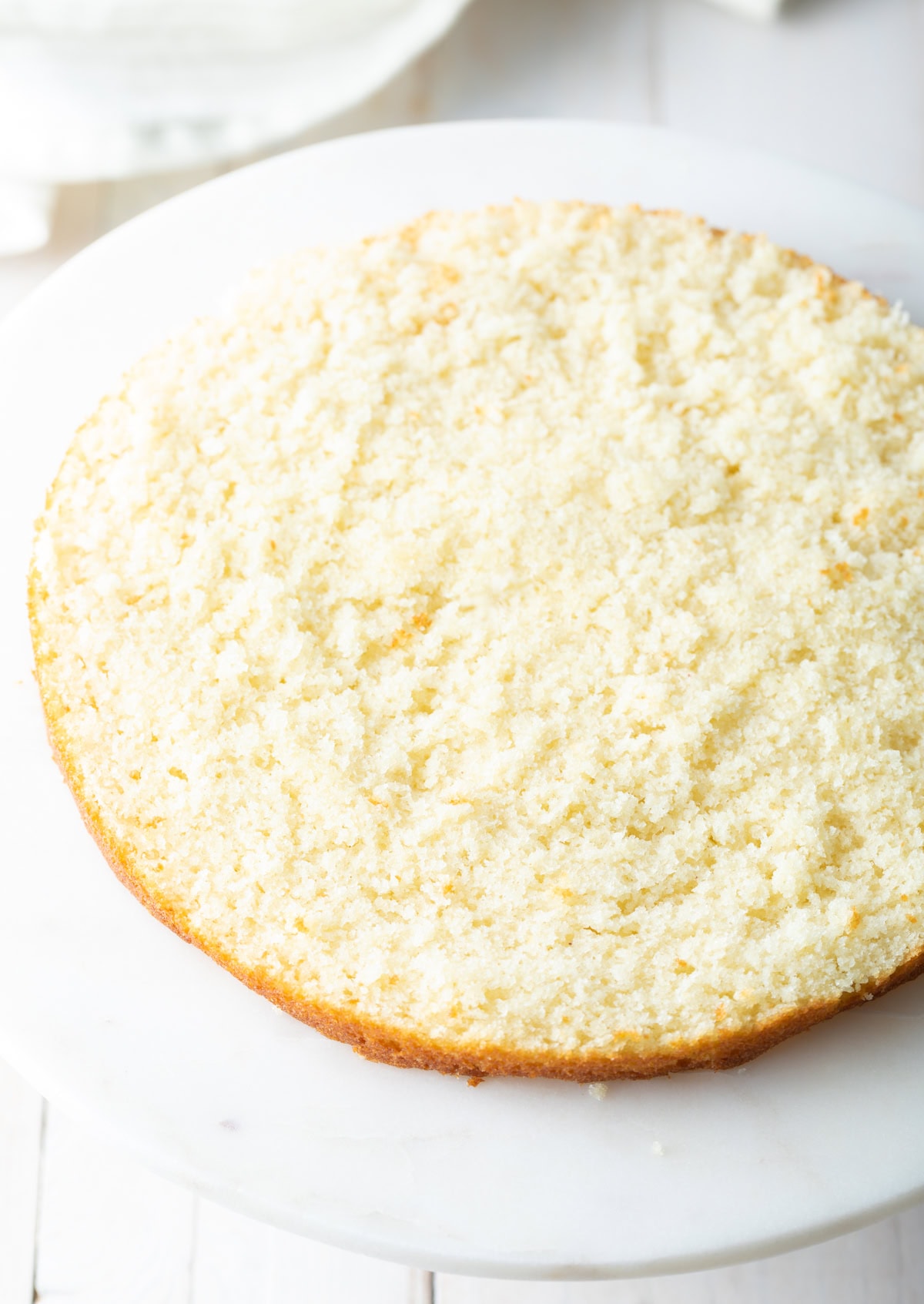 Sliced cake layer on a cake pan. 