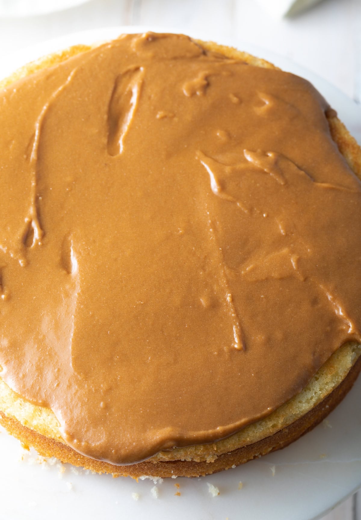 Top down view of half-decorated cake. 