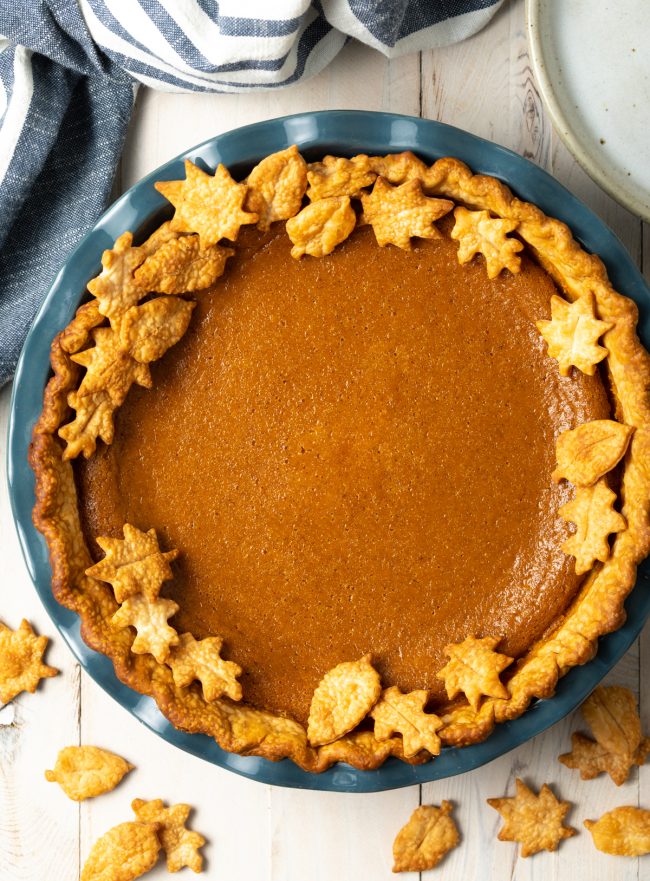 pumpkin pie with pumpkin spice overhead with leaf decorations