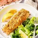 Salmon with a parmesan herb crust with a few bites missing at the end.