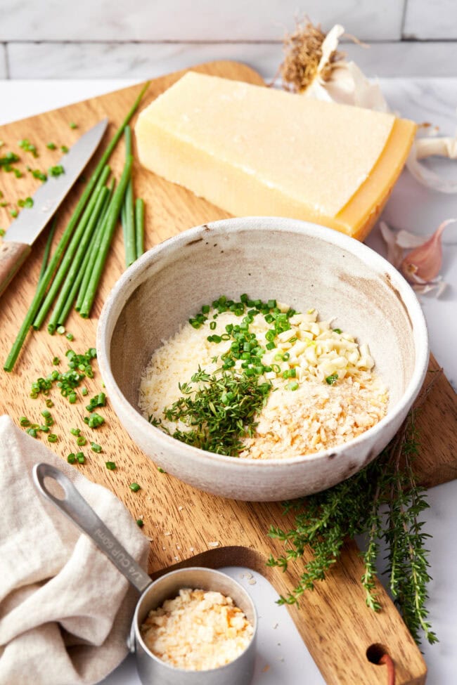 Bowl of breadcrumbs and chopped chives.