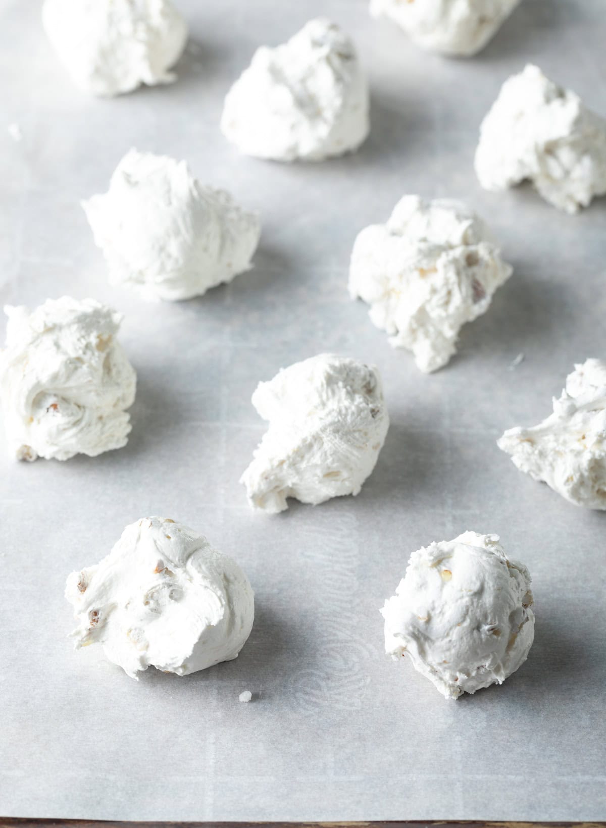 Portioned individual candies on parchment paper.