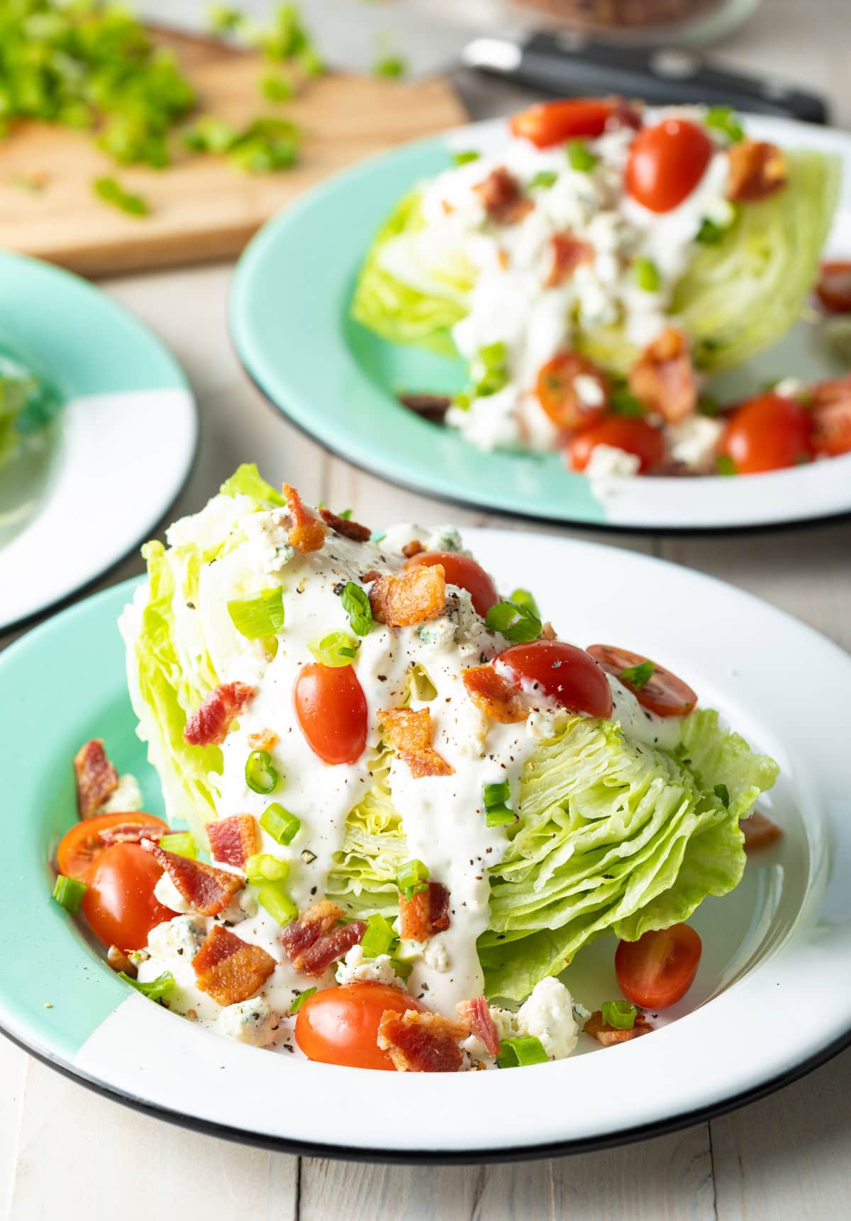 Ultimate wedge salad recipe with cherry tomatoes, bacon, and blue cheese crumbles