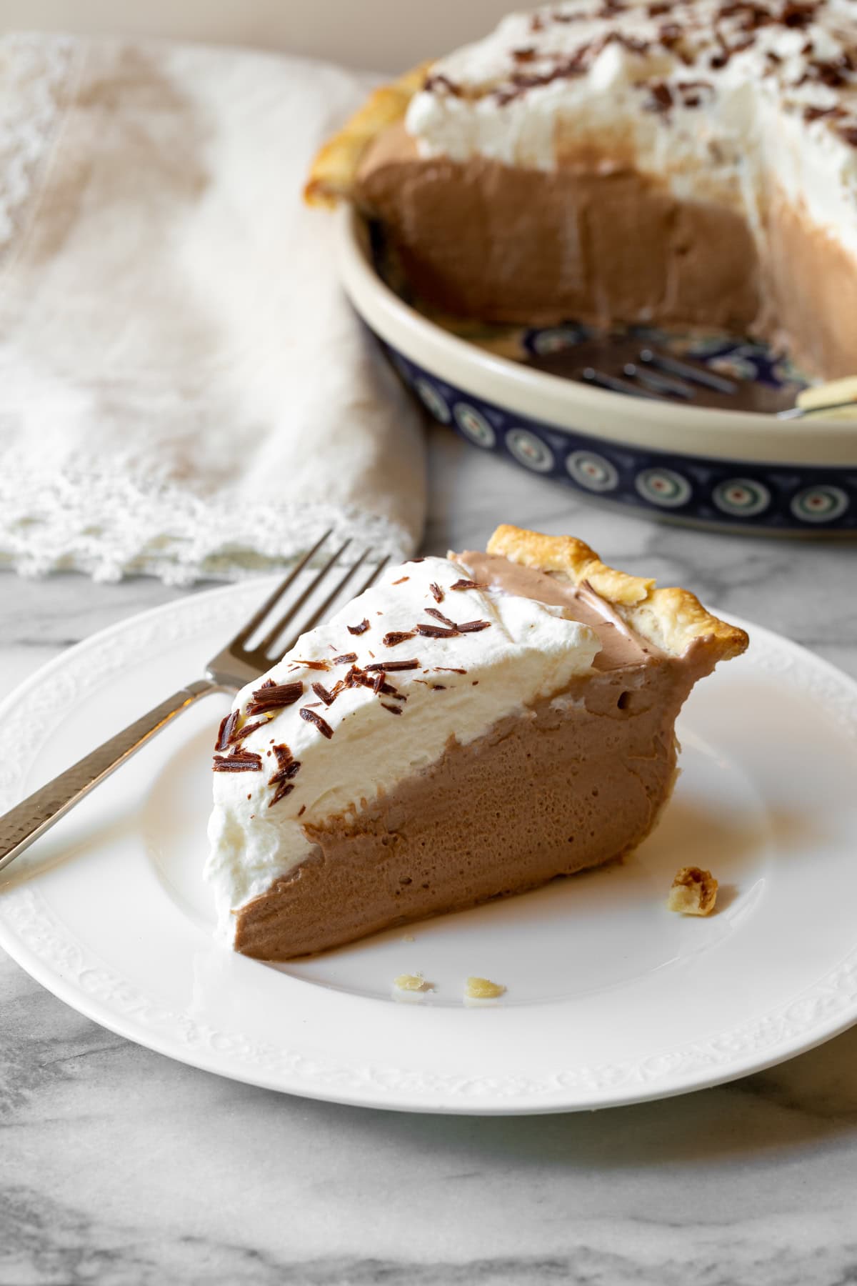 Closeup of pie on a plate served with a fork. 