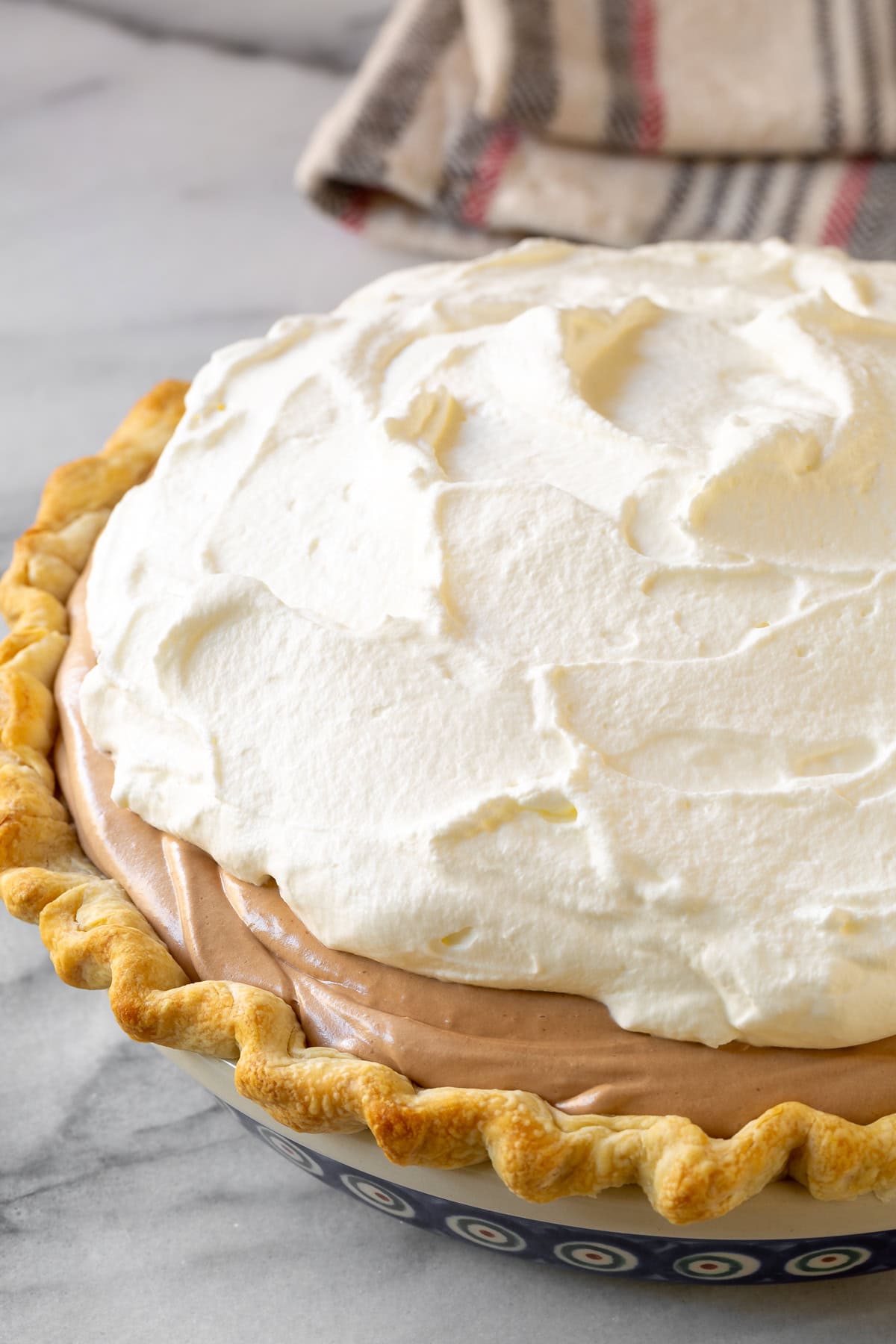 Pie crust topped with chocolate filling and whipped cream. 