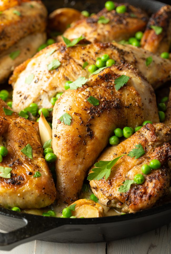 baked chicken and potatoes with peas