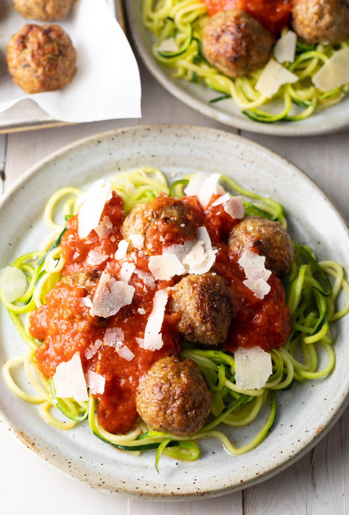healthy baked turkey meatballs on a plate with zucchini noodles