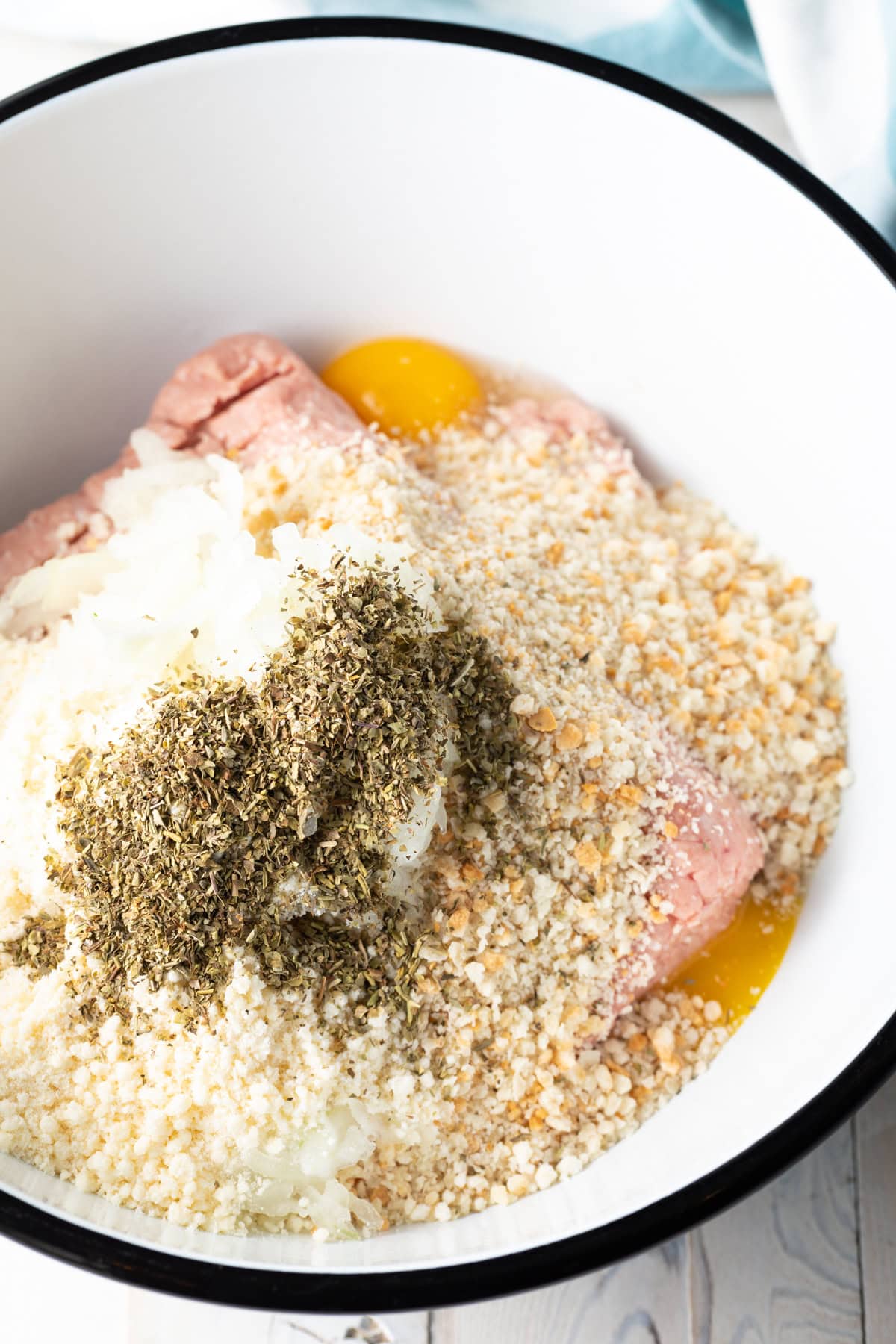 Unmixed turkey meatball ingredients in a mixing bowl.