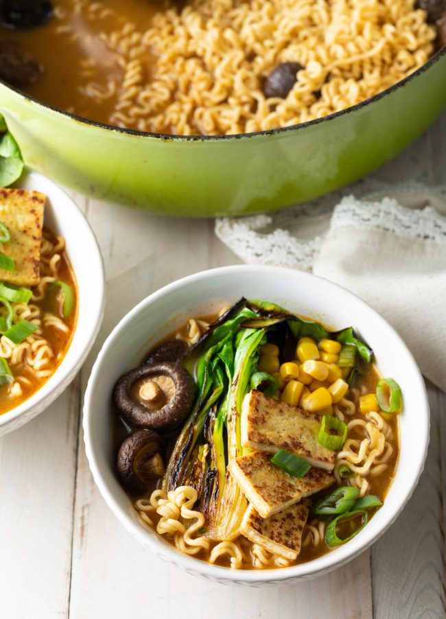 Top view of this vegan ramen noodle soup with tofu, bok choy and mushrooms 
