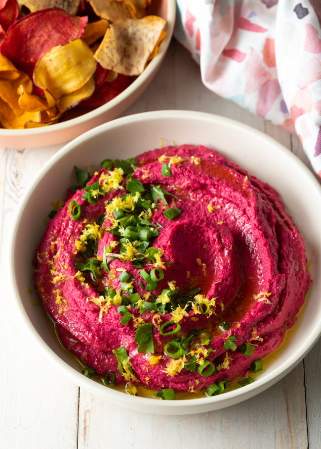 pink beet hummus with lemon zest, onions and cilantro