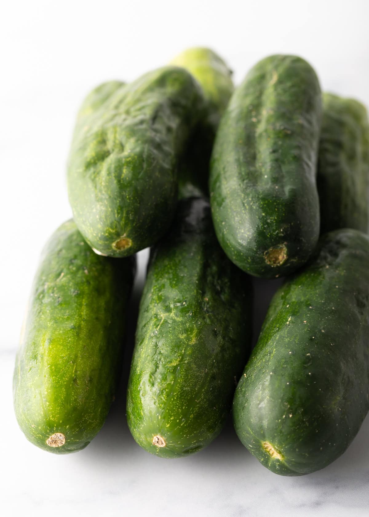 Cucumbers piled on top of each other.
